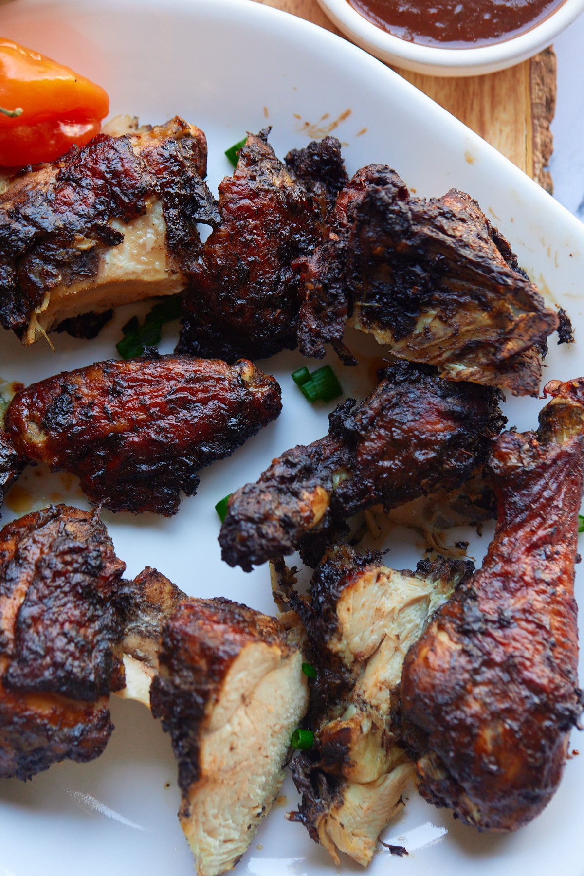 Jamaican jerk chicken on a white plate.