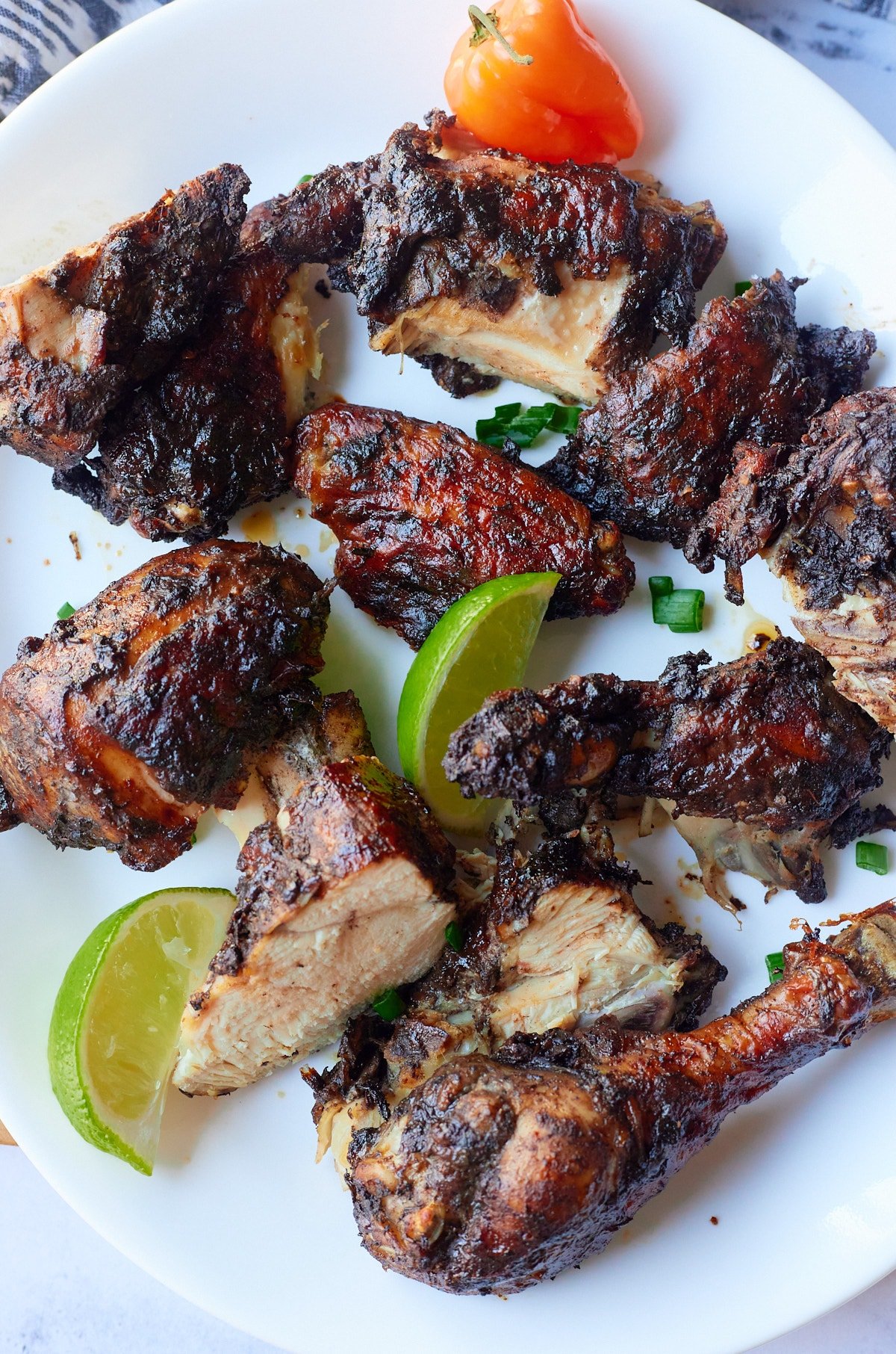 Jamaican jerk chicken cut up on a plate ready to eat.