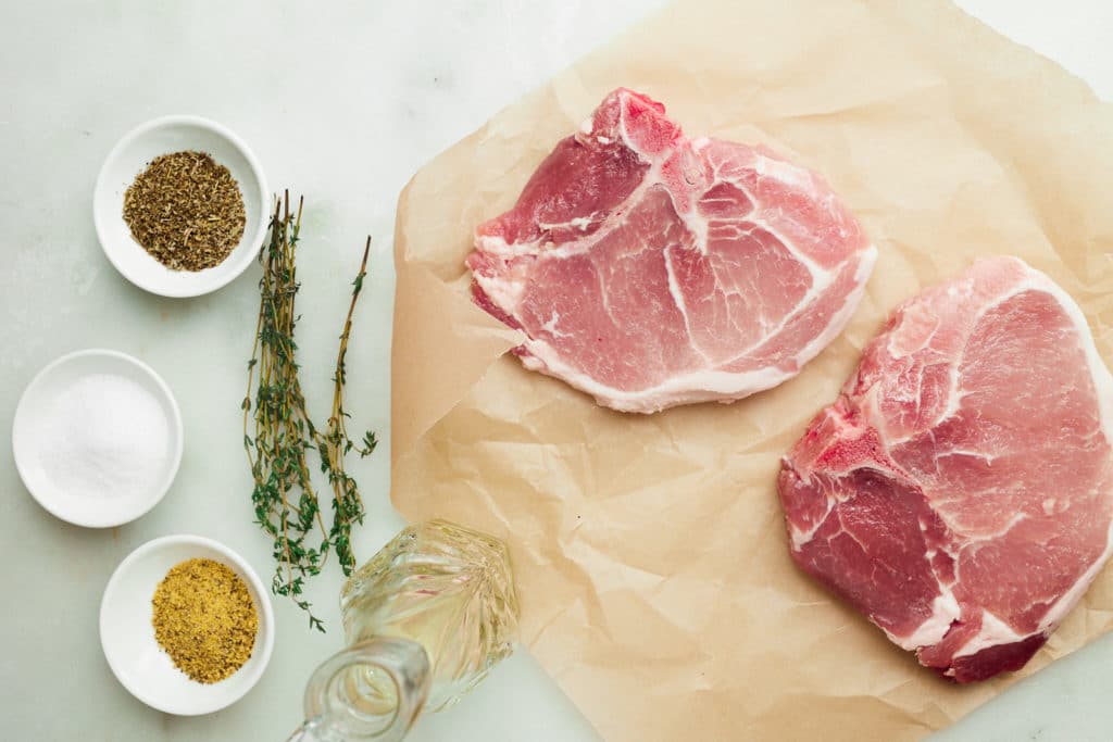 ingredients for pork chops on white table