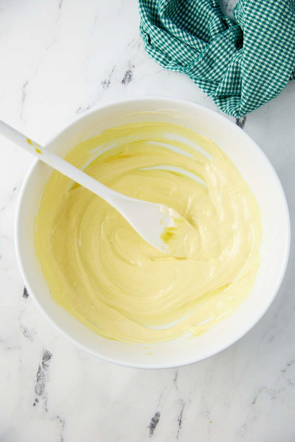 The ingredients for the mayonnaise dressing mixed together in a white bowl