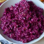 Red cabbage vinegar coleslaw served in a white bowl.