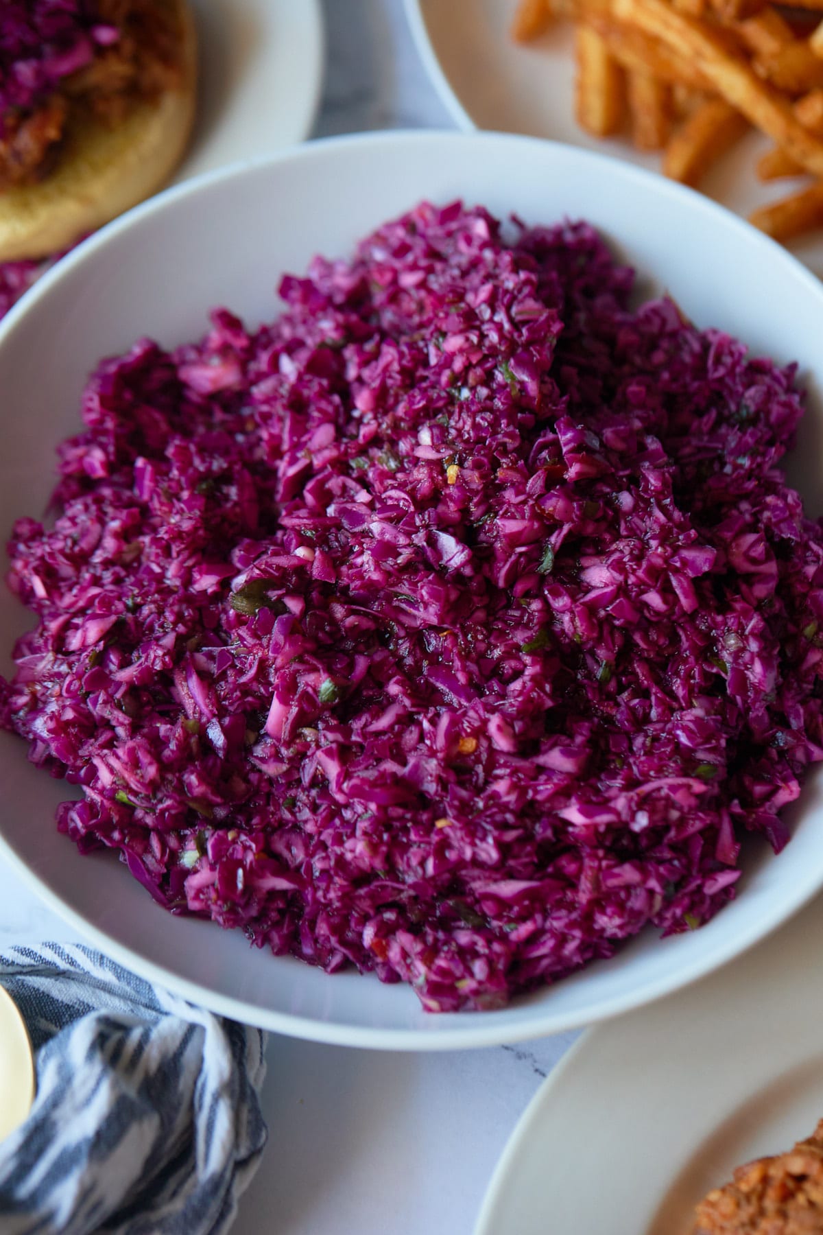 Red cabbage vinegar coleslaw served in a white bowl.