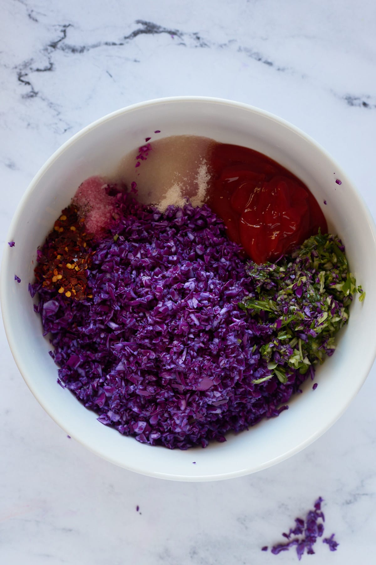 The ingredients for the slaw in a white bowl.