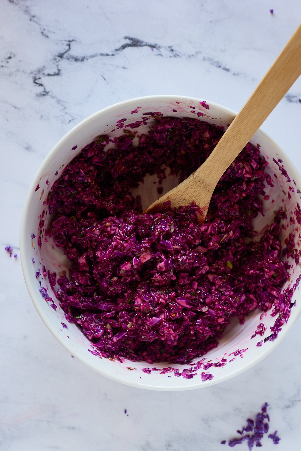 A wooden spoon mixing the ingredients together.