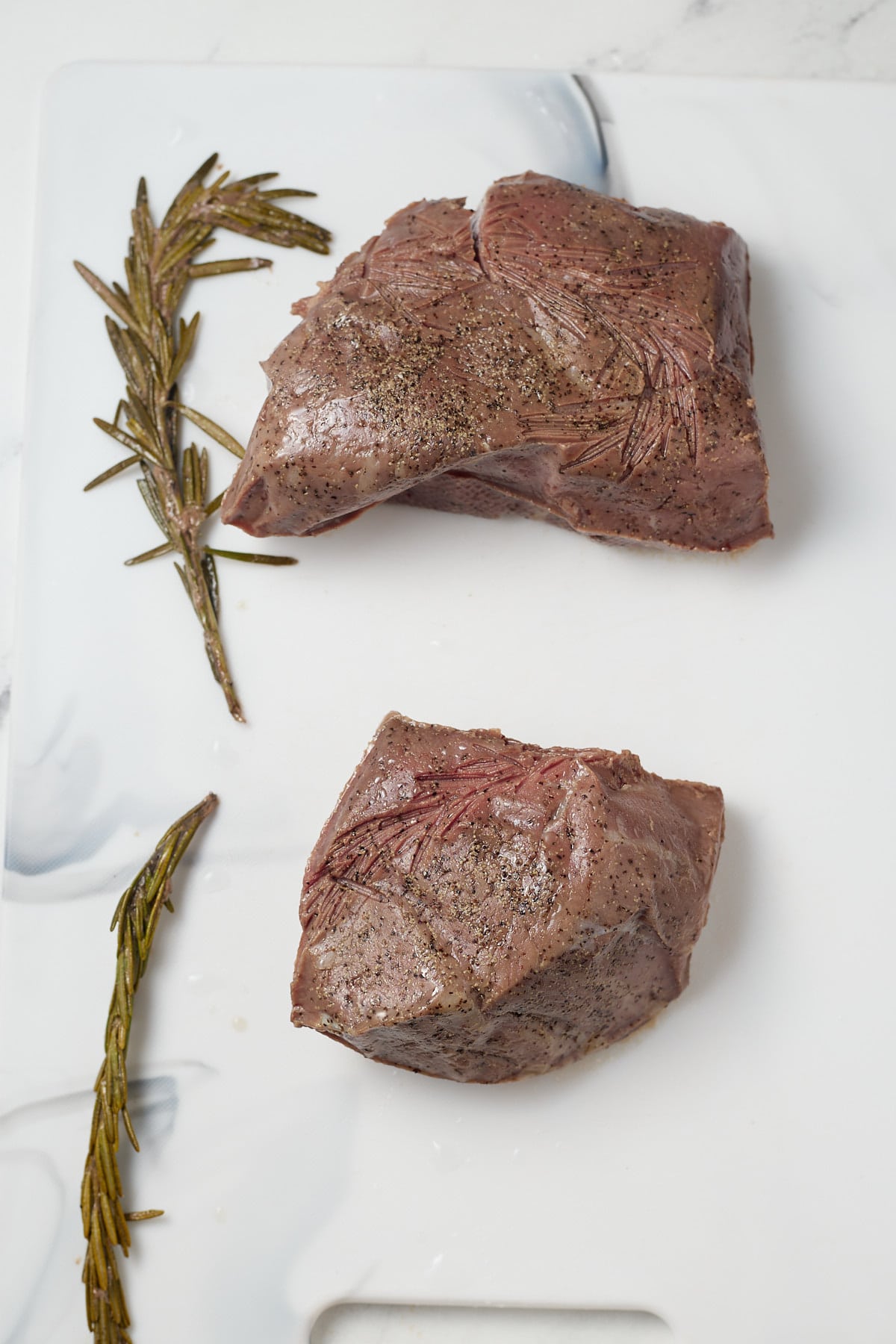 The cook steaks on a work top.