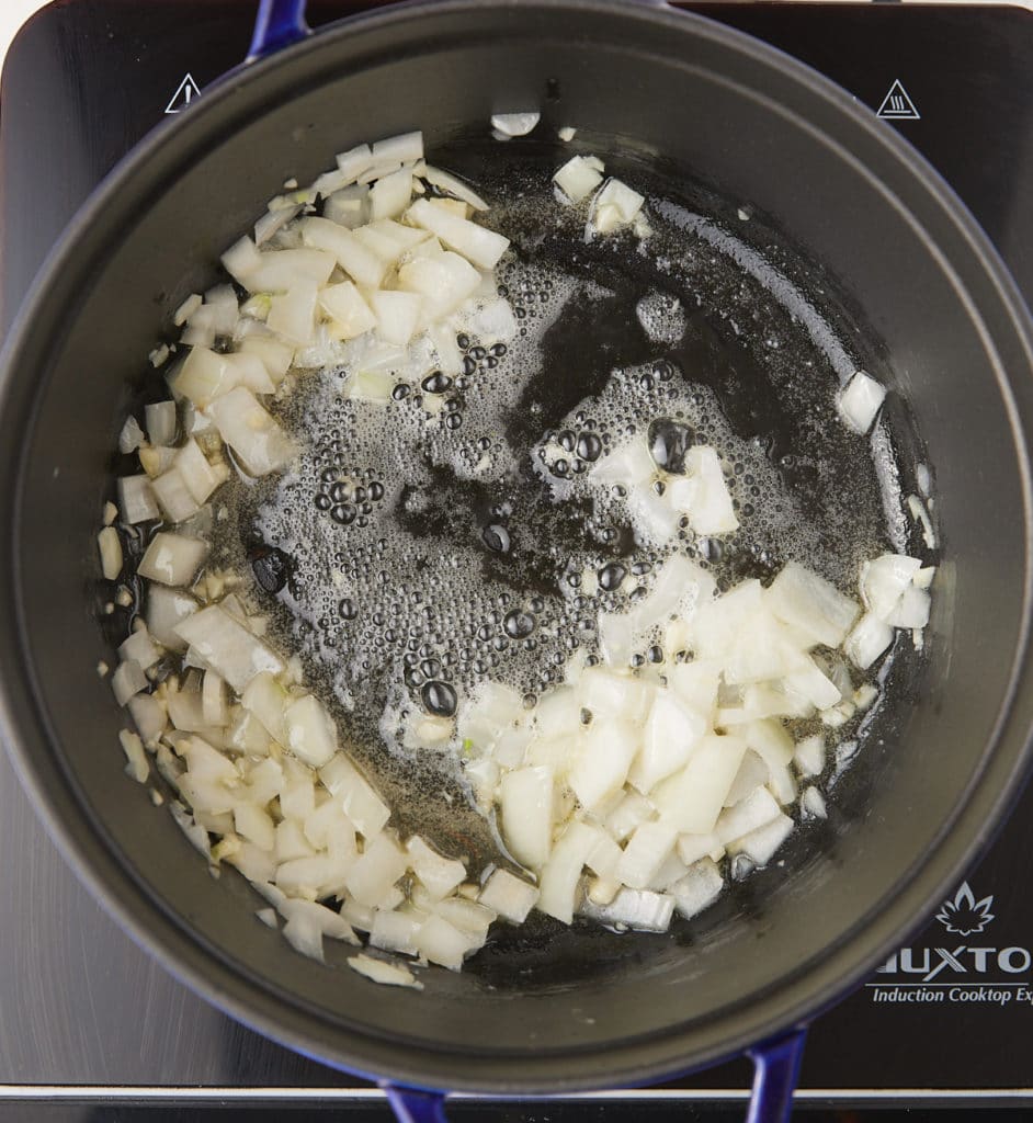 Sautéing the onions on a pan.