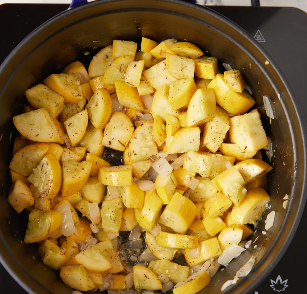 Cooking the squash and spices in a pan.