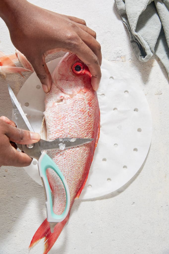 Removing the scales from the fish.