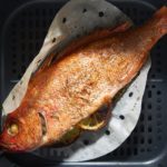 The cooked whole fish in the air fryer basket.