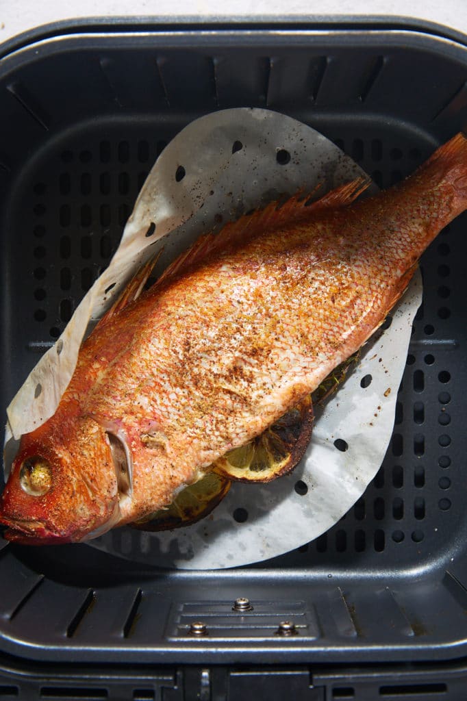 The cooked whole fish in the air fryer basket.