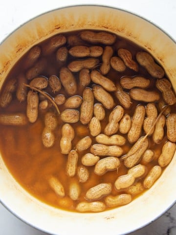 The cooked peanuts in a large pot.