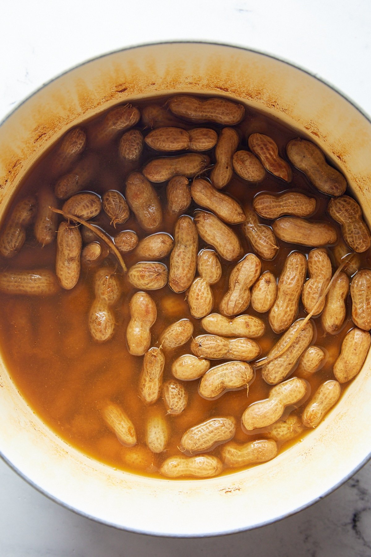 The cooked peanuts in a large pot.