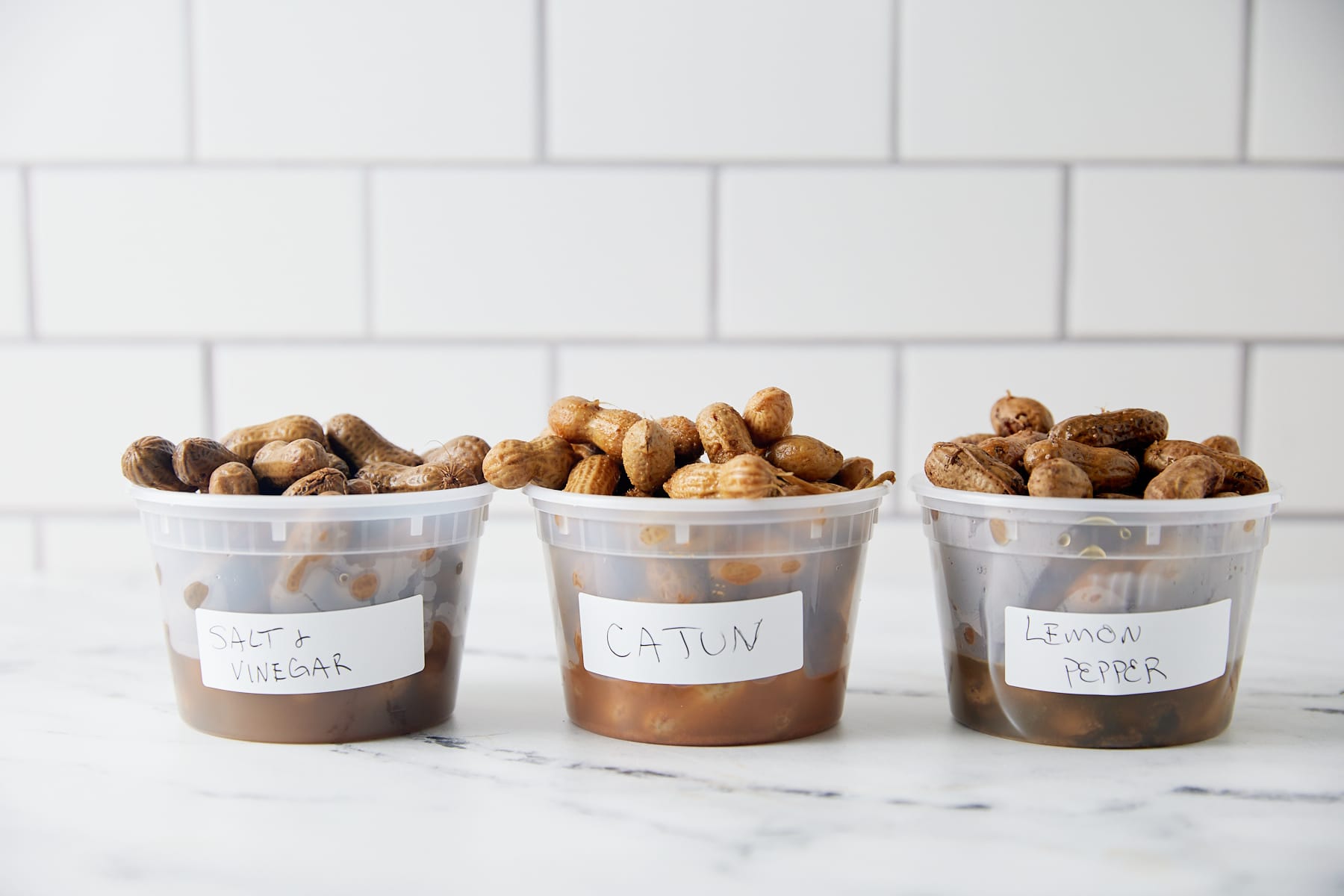 Flavored boiled peanuts in plastic cups.