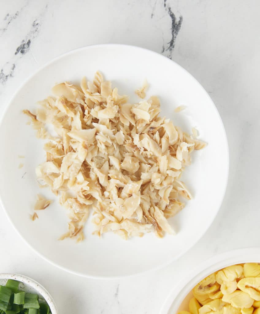 shredded cooked codfish on white plate