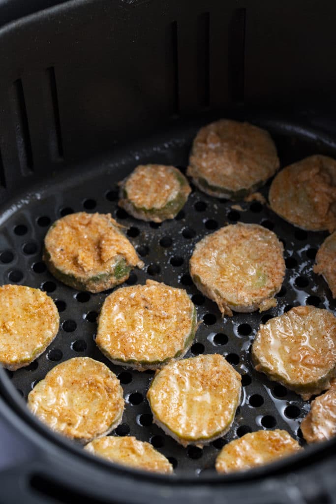 The cooked pickles in the air fryer basket.