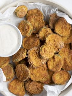 Fried pickles served with a creamy dip.