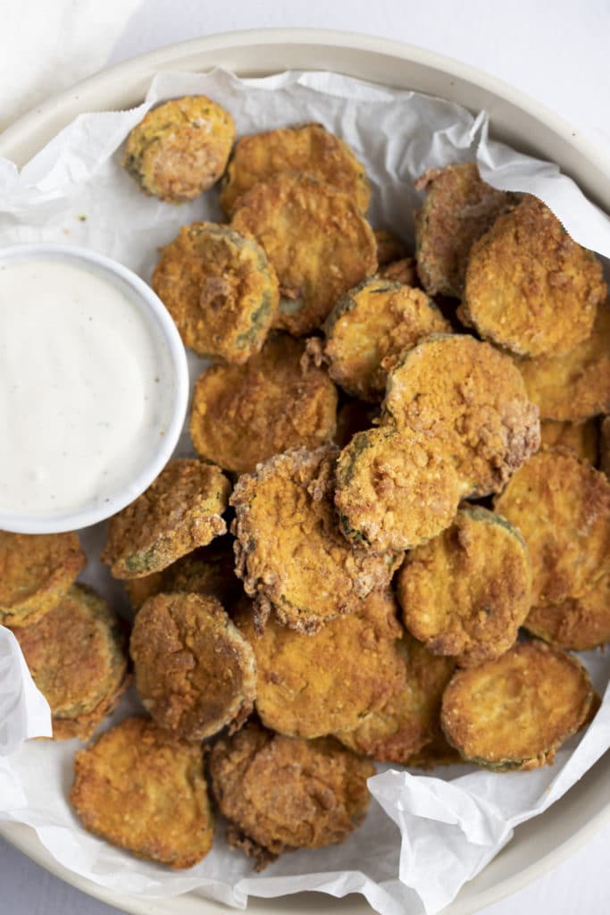 Fried pickles served with a creamy dip.