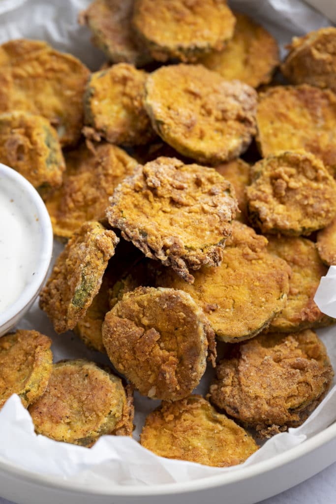 Close up of air fryer fried pickles in a serving bowl.