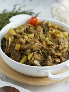 Jamaican curry goat in white bowl