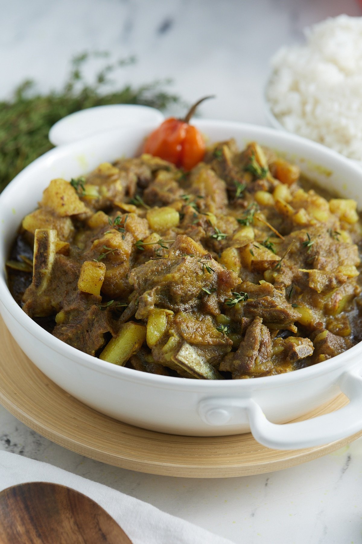 Jamaican curry goat in white bowl