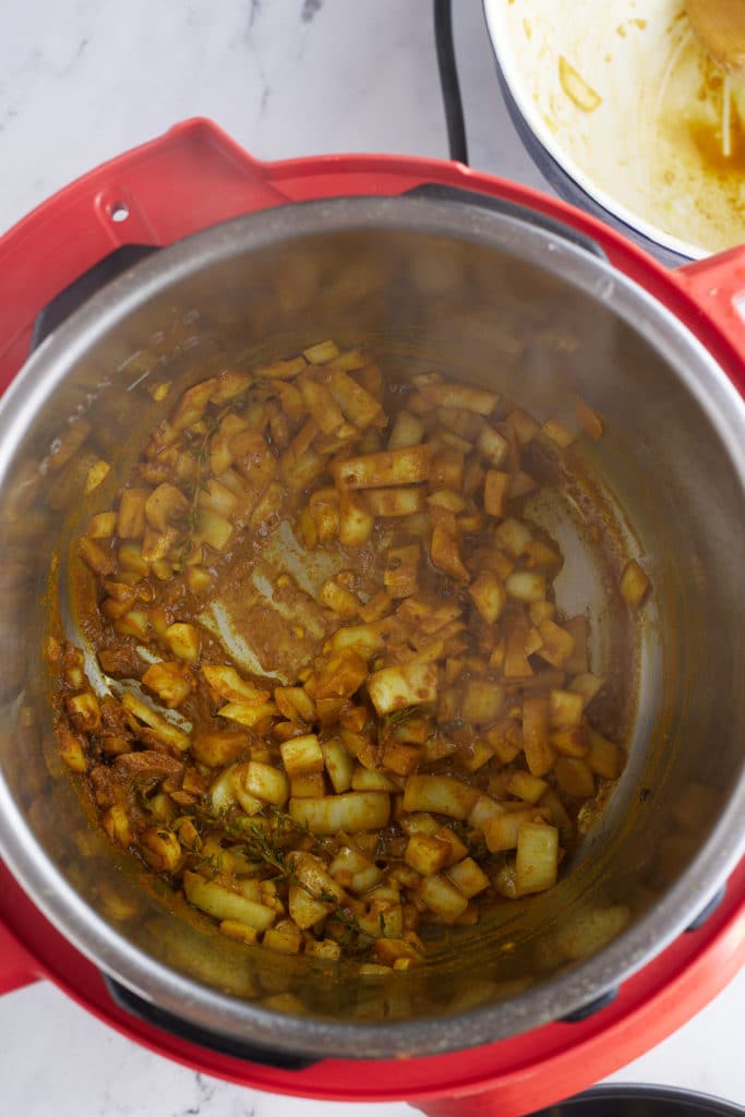 onions being sauteed in an instant pot pressure cooker