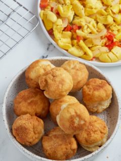 fried dumplings sitting in bowl with ackee in a bowl to the right