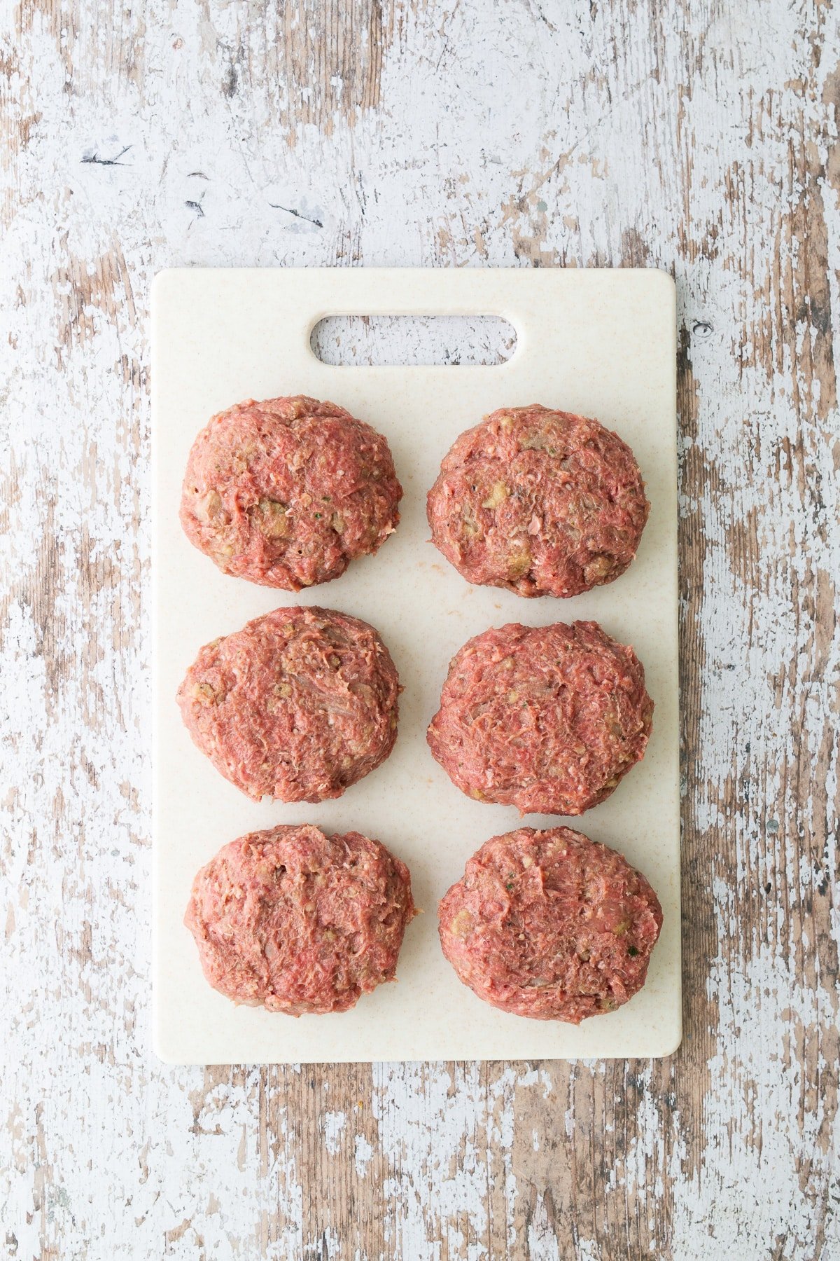 beef patties on cutting board