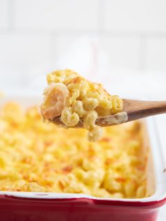 Mac and cheese on a wooden spoon.