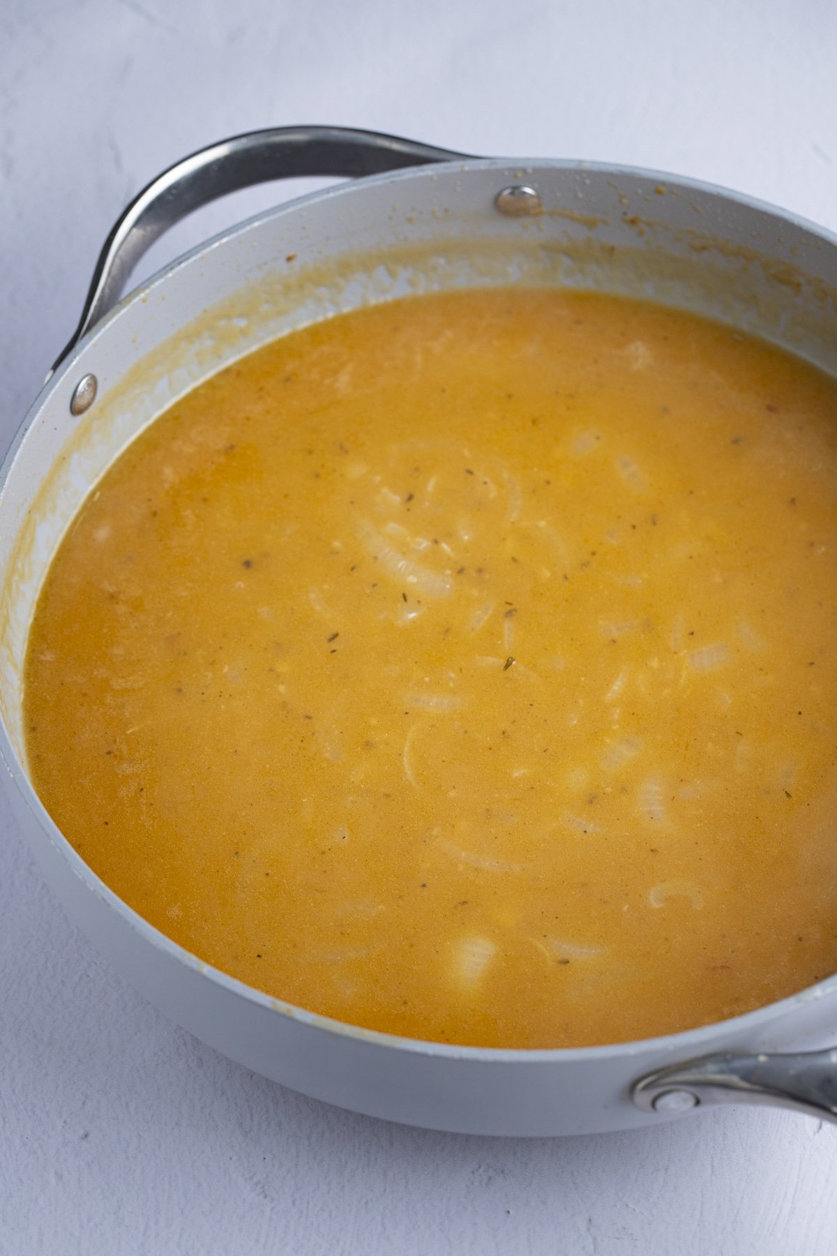 Stock and drippings added to the pan to make the gravy.