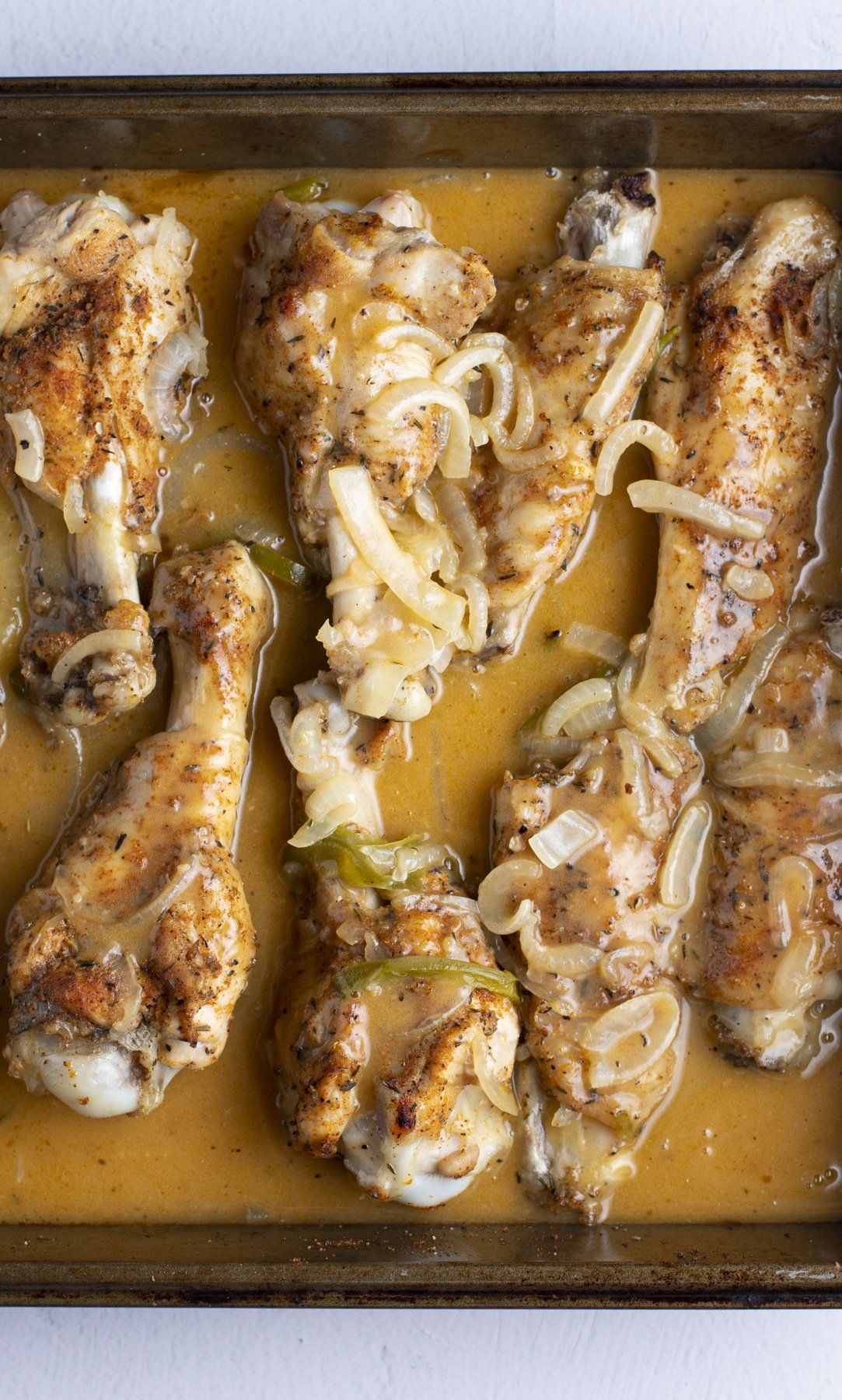 Gravy poured over the baked turkey wings.