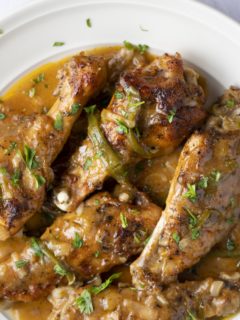 Cooked turey wings and gravy ready to serve.