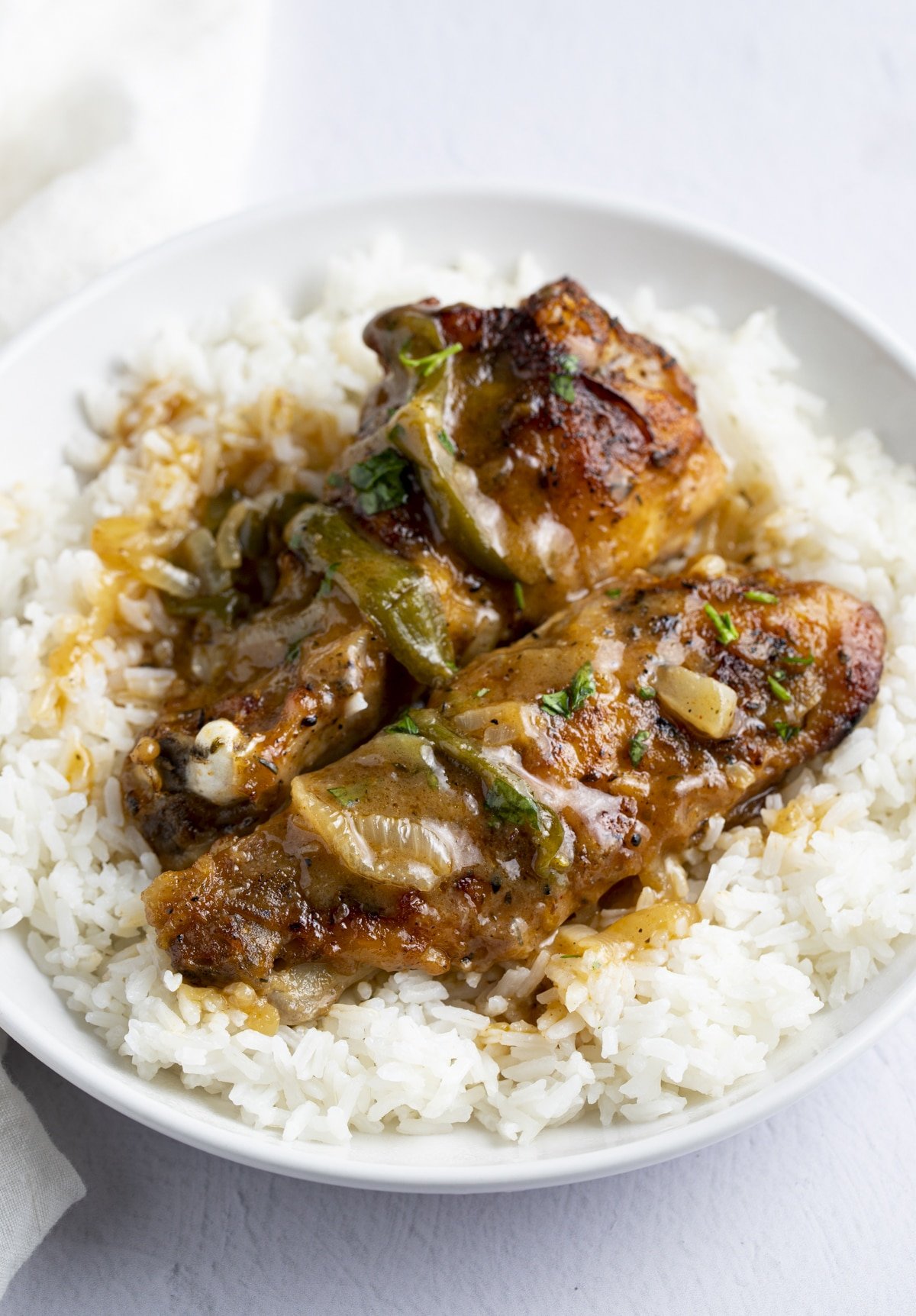 Two smothered turkey wings served on rice.