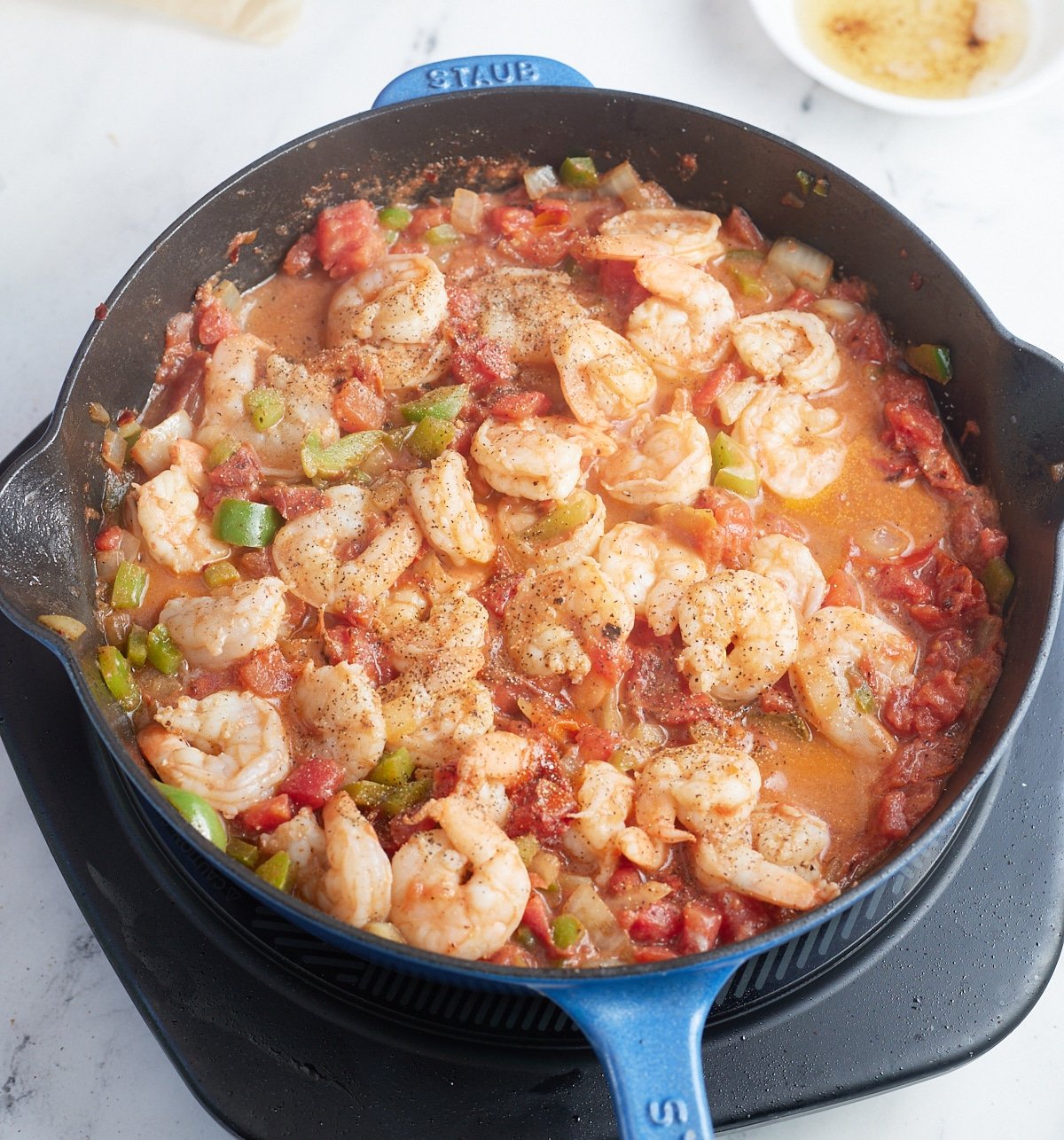 The cooked shrimp in a skillet.
