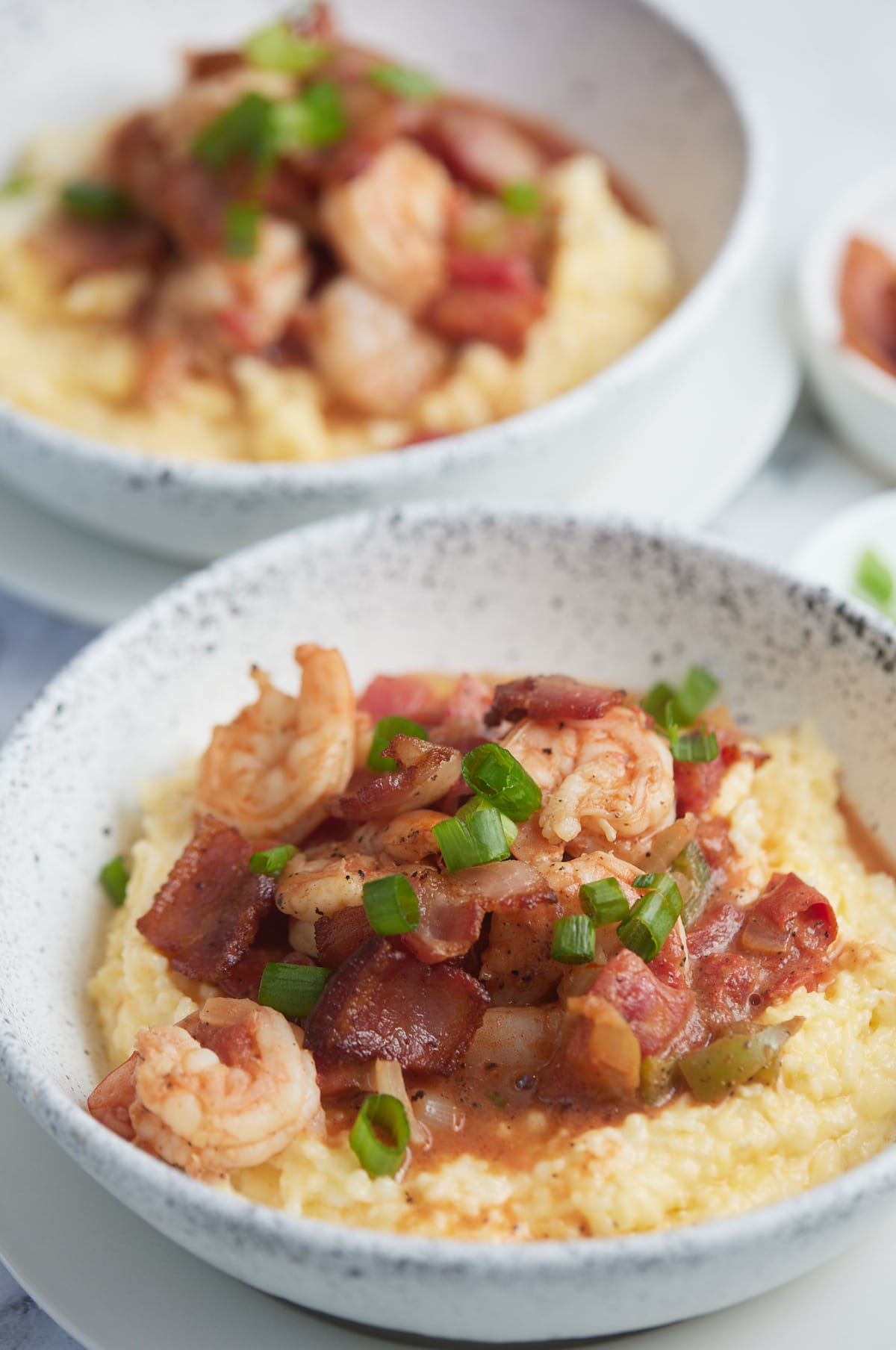 Tow bowls of Southern style shrimp and grits.