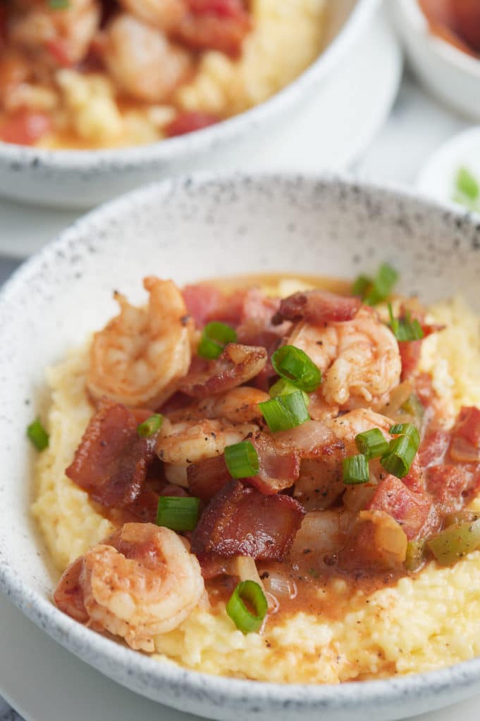 Close up of the cooked shrimp served on top of the cheesy grits.