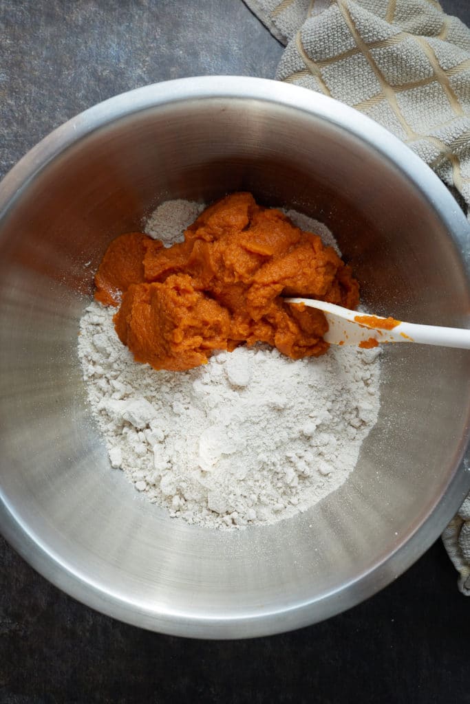 Cake mix and pumpkin puree in a mixing bowl.