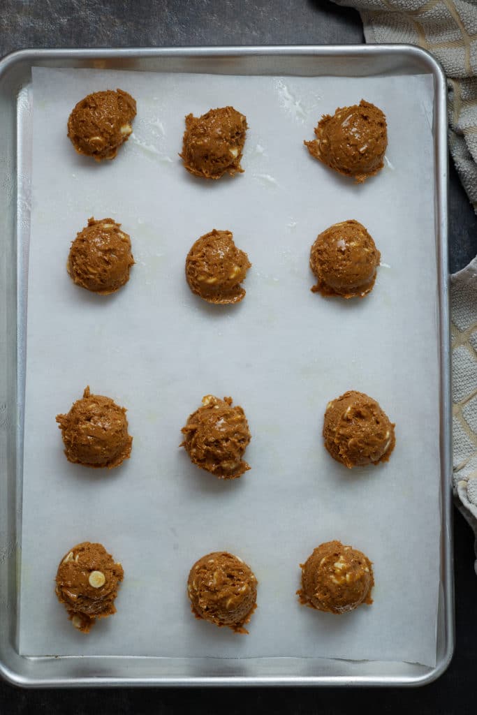 Balls of cookie dough on a baking sheet.