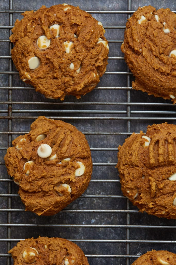 Six cookies cooling on a wire rack.