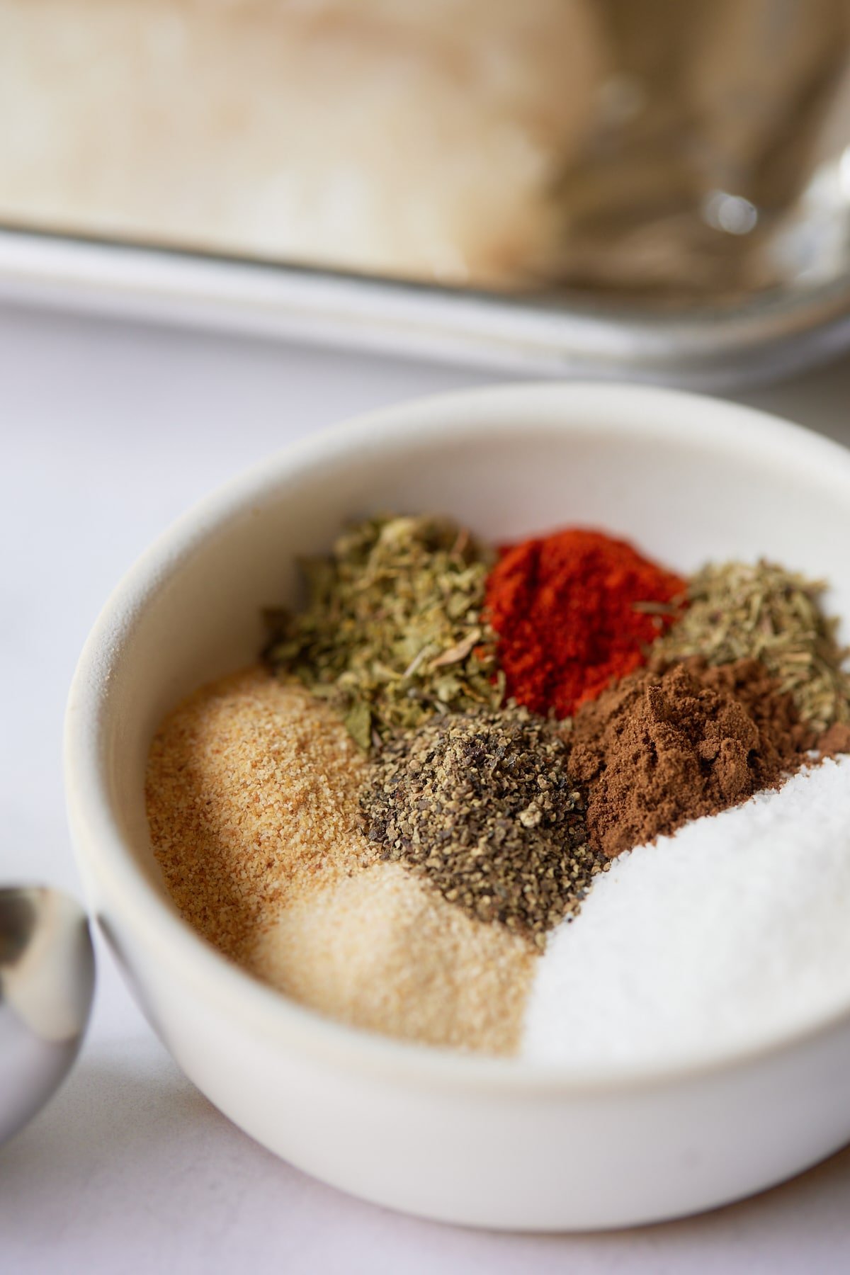 Close up of the seasonings in a small white bowl.