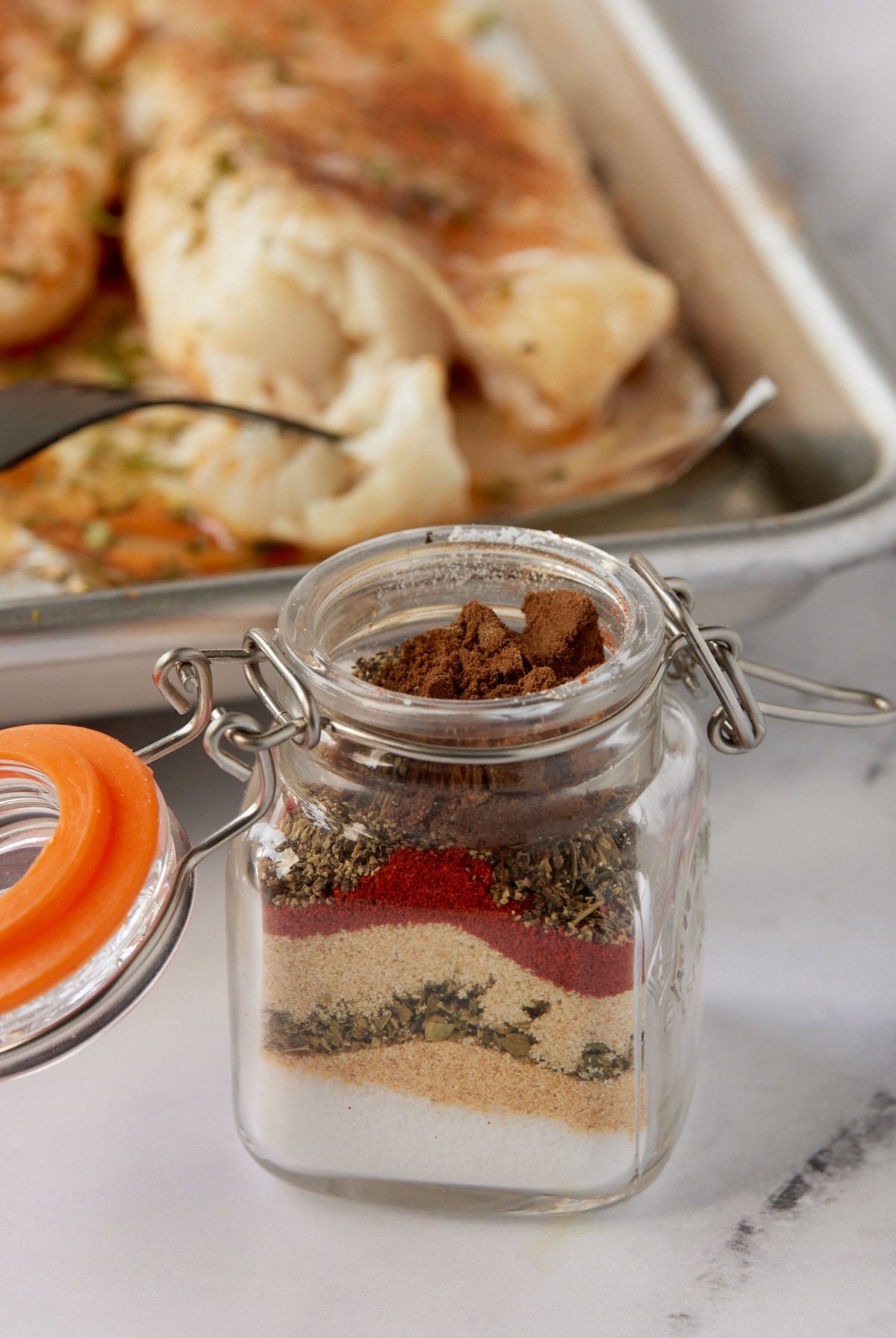 The seasonings layered in a small glass jar.