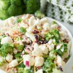 Broccoli and cauliflower salad in a white bowl.