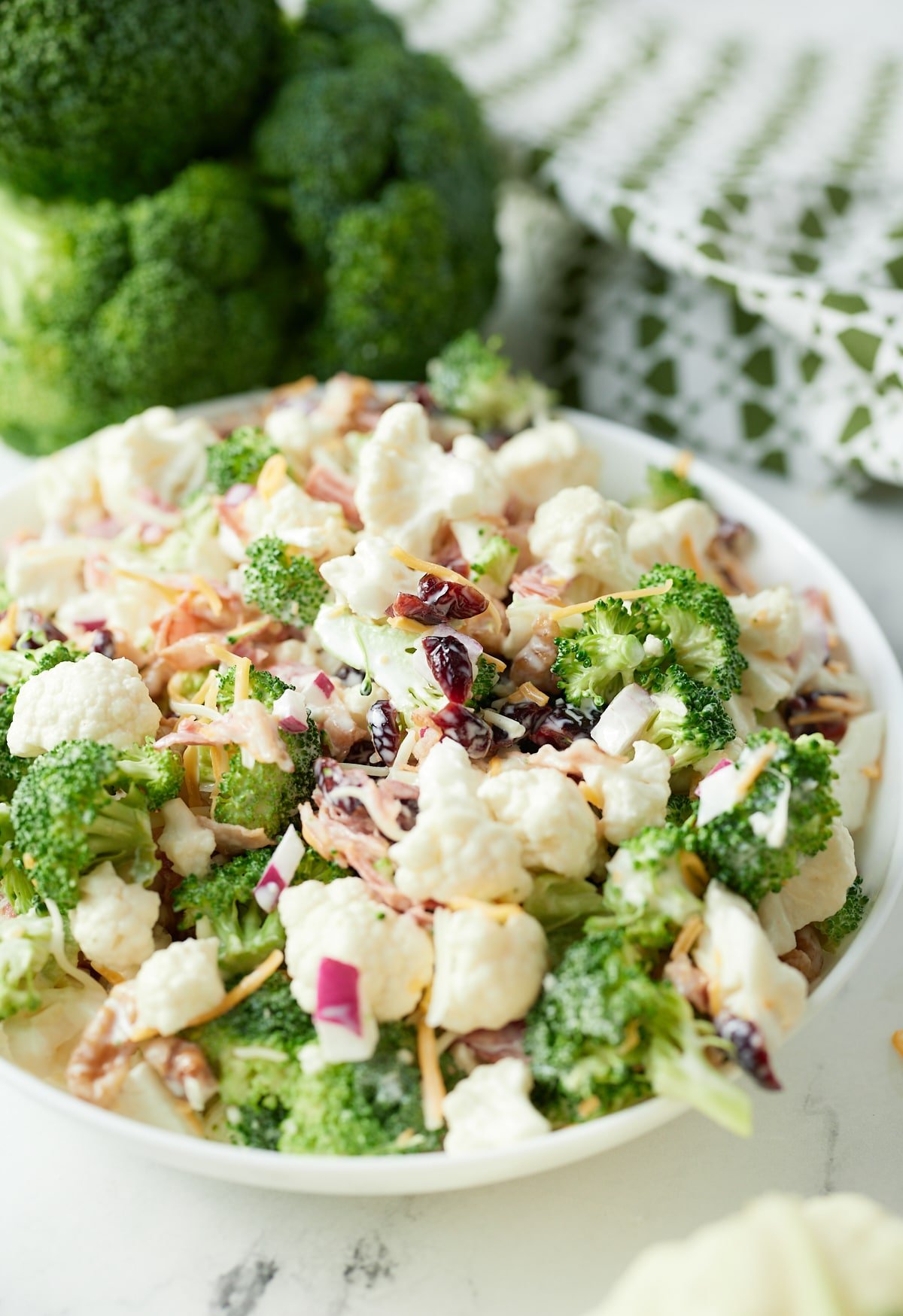 Broccoli and cauliflower salad in a white bowl.