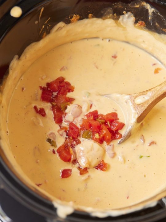 Cheesy hot shrimp dip with spoon sticking out