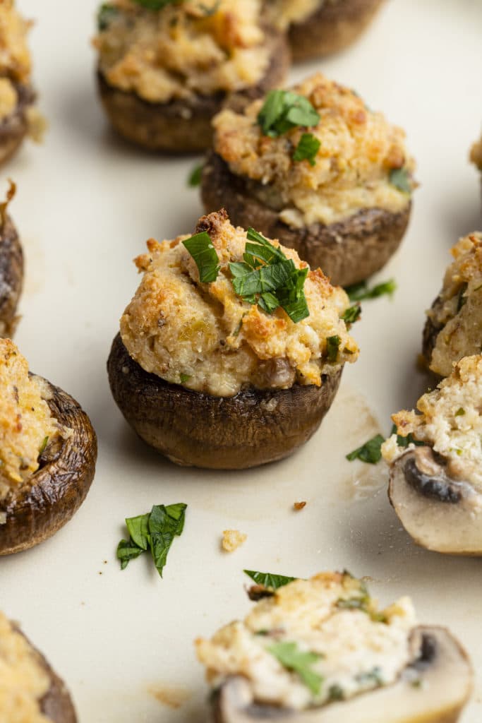 Close up of baked cream cheese stuffed mushrooms.