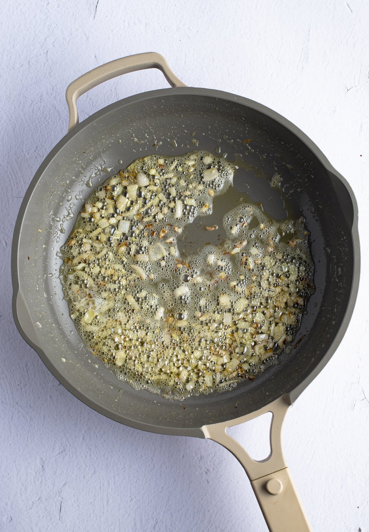 Cooking the shallots in a skillet.