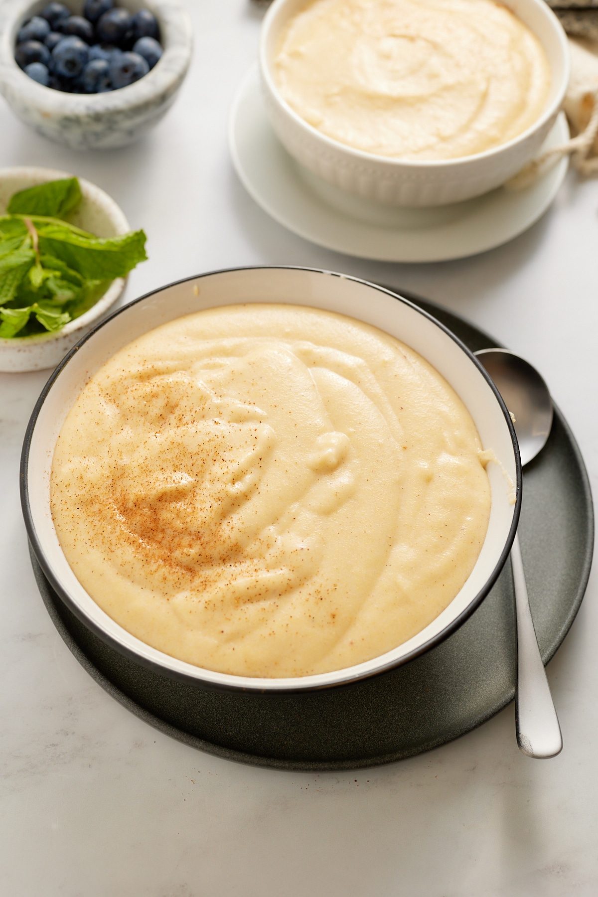 cornmeal porridge in bowl with spoon on side