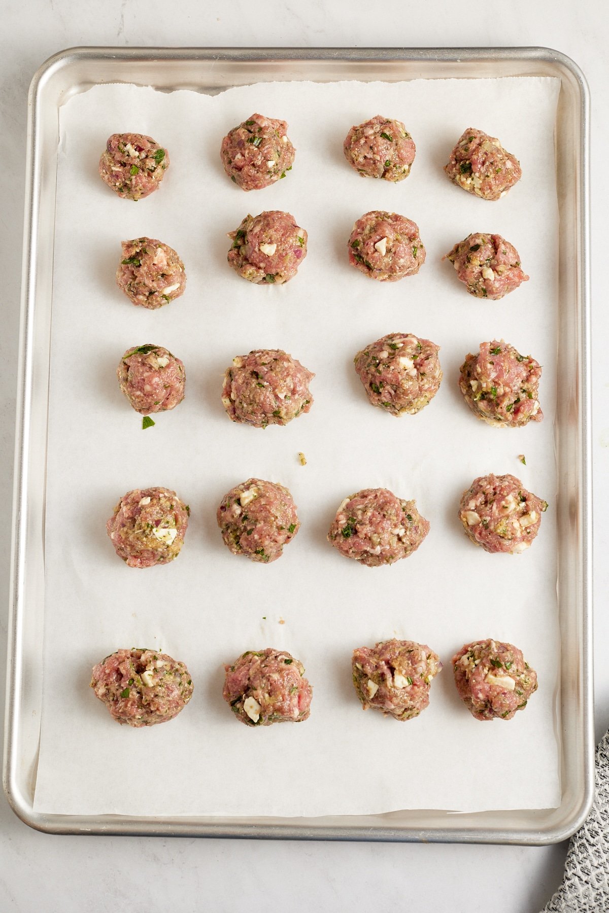 raw lamb meatballs on lined sheet