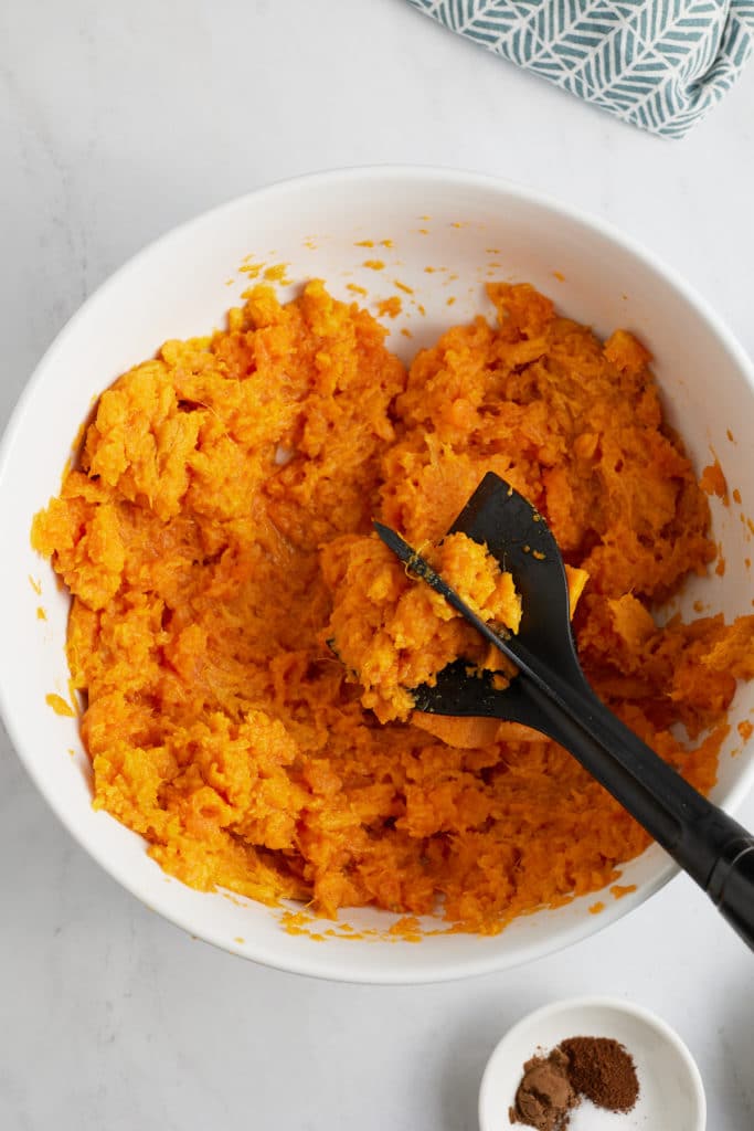 sweet potato in bowl with masher