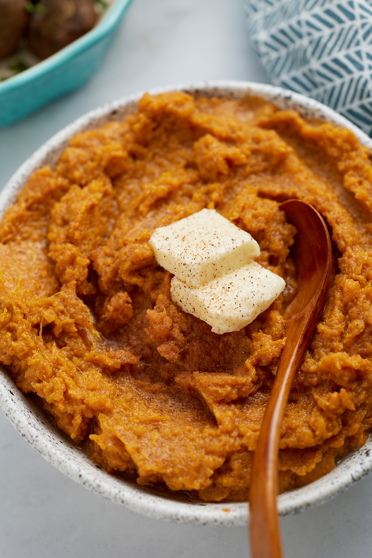 sweet potatoes with butter on top and spoon sticking out