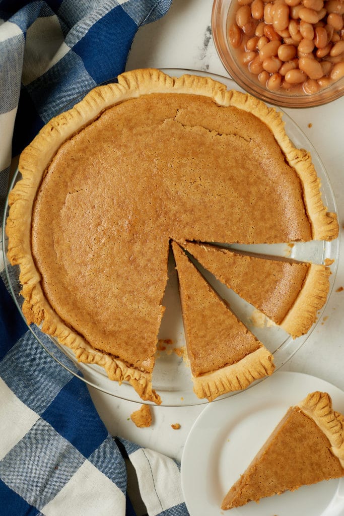 A pinto bean pie with slices cut out of it.